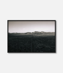 Black and white desert landscape wall art with distant hills