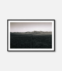 Black and white desert landscape wall art with distant hills