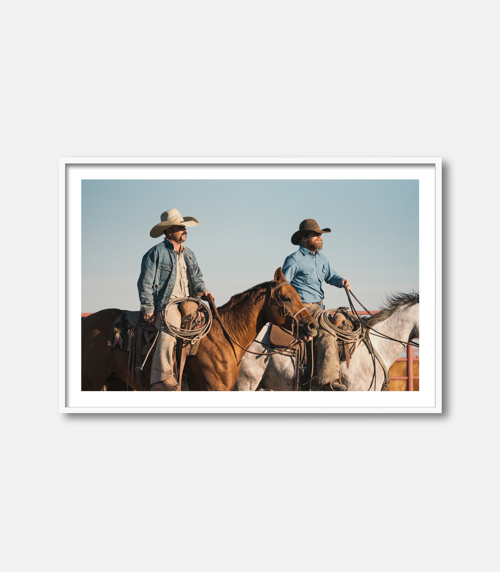 Framed western photography of cowboys on horseback, bold statement wall art